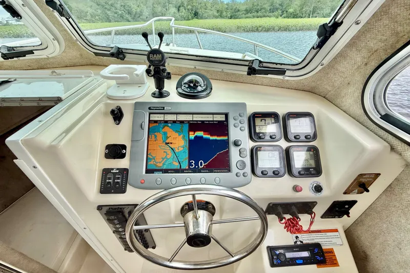 Slide: The Image of Helm of 2008 Parker 2520XLD boat with navigation and control instruments. - 9