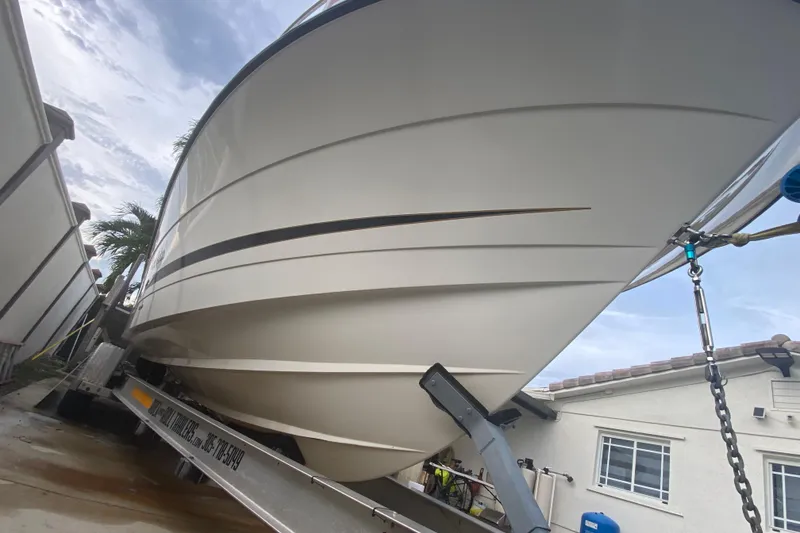 Slide: The Image of 2004 Hydra-Sports Vector 2800 WA boat on trailer, viewed from below, near buildings. - 10