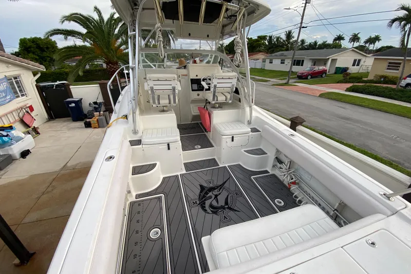 Slide: The Image of 2004 Hydra-Sports Vector 2800 WA boat interior with seating and fishing gear. - 11