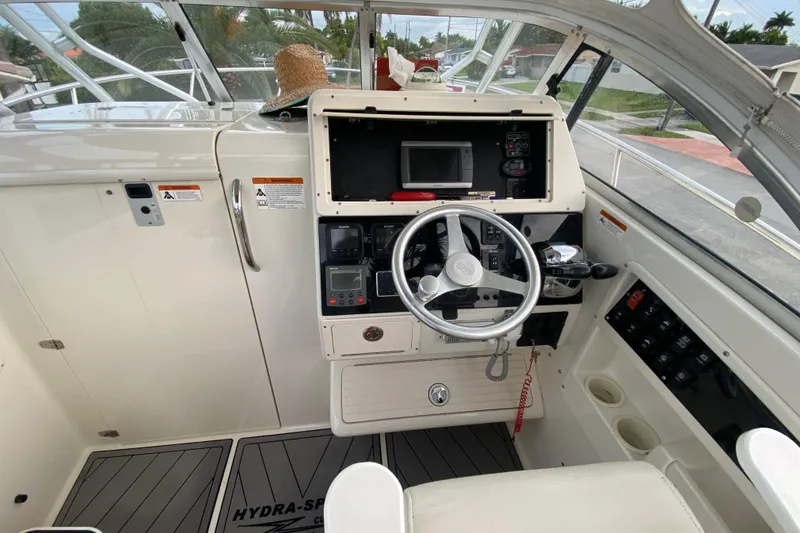 Slide: The Image of 2004 Hydra-Sports Vector 2800 WA helm with steering wheel, controls, and navigation equipment. - 14