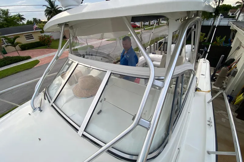 Slide: The Image of 2004 Hydra-Sports Vector 2800 WA boat with a person onboard, parked in a residential area. - 19