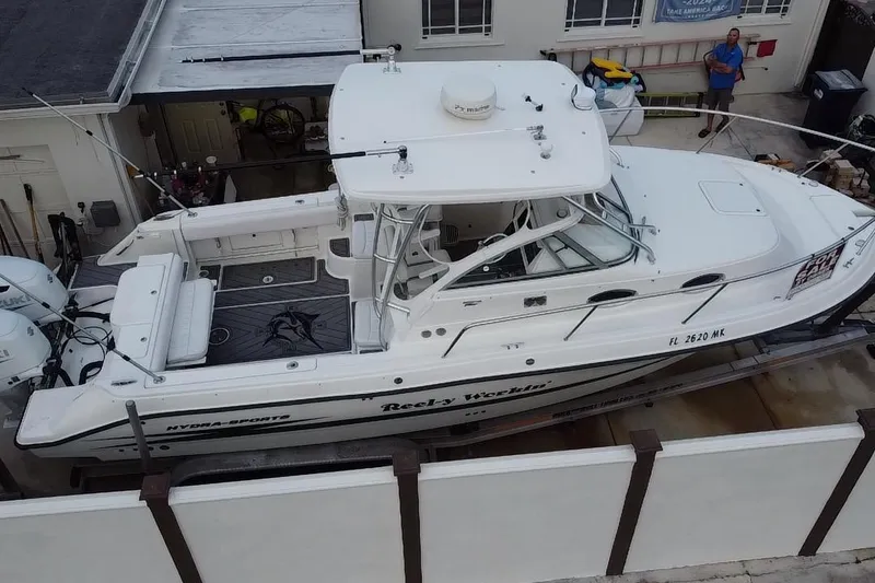 Slide: The Image of 2004 Hydra-Sports Vector 2800 WA boat docked, white exterior, for sale sign visible. - 25