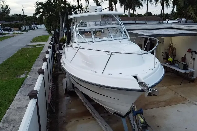 Slide: The Image of 2004 Hydra-Sports Vector 2800 WA boat on trailer, parked beside a house. - 3