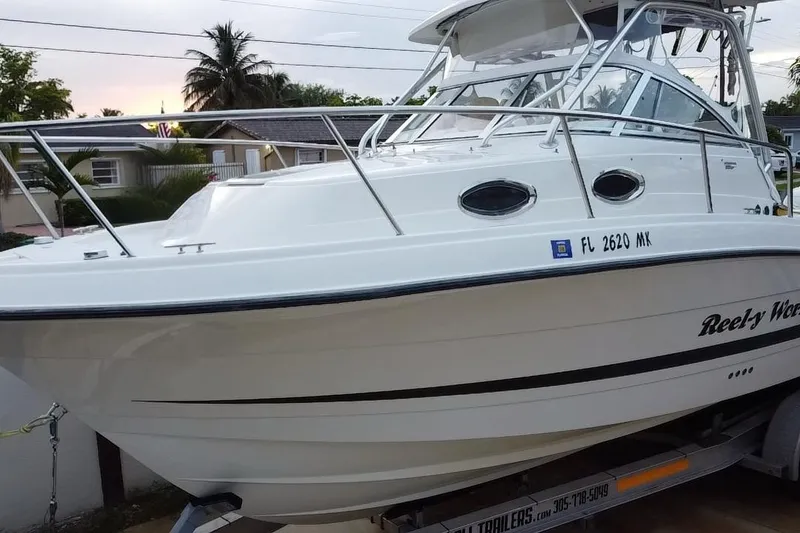 Slide: The Image of 2004 Hydra-Sports Vector 2800 WA boat on trailer, side view with palm trees in background. - 6