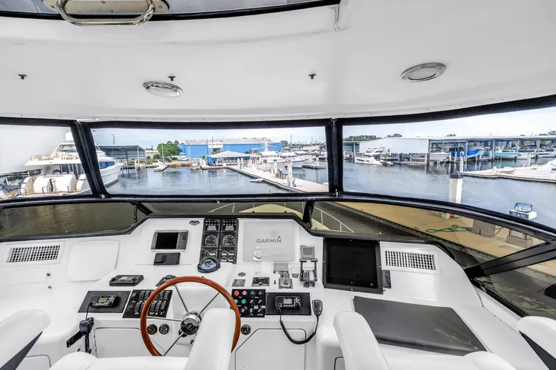 Slide: The Image of Flybridge helm of 2000 Neptunus 65 yacht with marina view. - 10