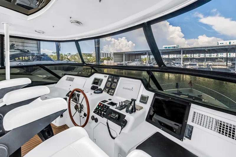 Slide: The Image of Flybridge helm of 2000 Neptunus 65 yacht with modern navigation equipment and panoramic view. - 12