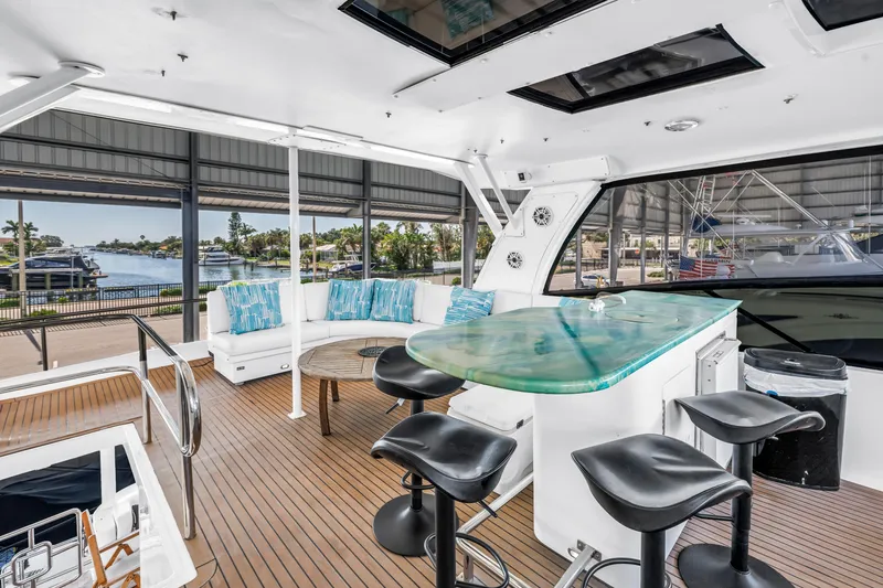 Slide: The Image of Luxurious 2000 Neptunus 65 Flybridge yacht interior with modern seating and scenic marina view. - 14
