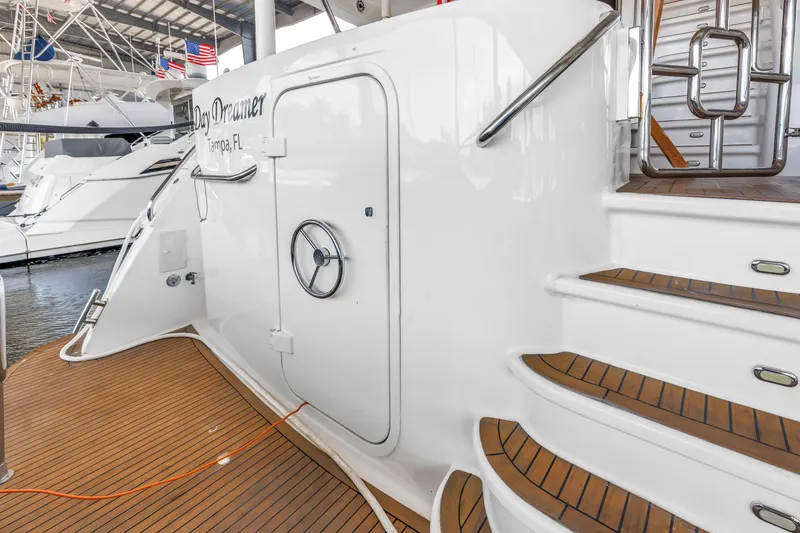 Slide: The Image of 2000 Neptunus 65 Flybridge yacht with teak deck and elegant staircase in marina. - 24