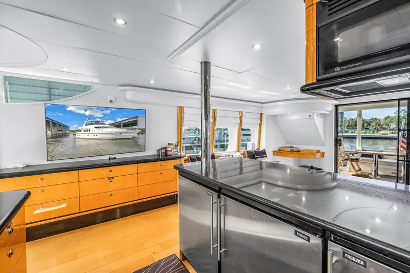 Slide: The Image of Luxurious interior of 2000 Neptunus 65 Flybridge yacht with modern kitchen and scenic views. - 34
