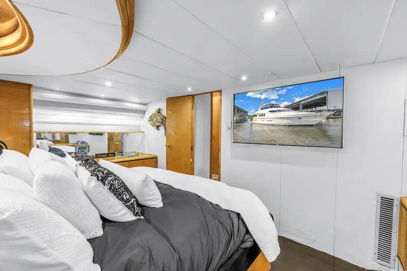 Slide: The Image of Luxurious Neptunus 65 Flybridge yacht bedroom with modern decor and wall-mounted TV, 2000 model. - 39