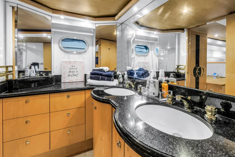 Slide: The Image of Luxurious bathroom in 2000 Neptunus 65 Flybridge yacht with dual sinks and elegant decor. - 40
