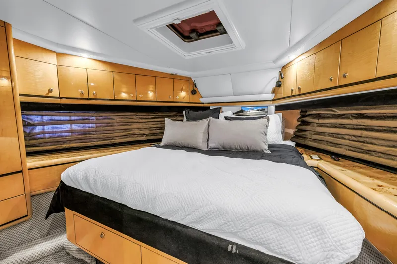 Slide: The Image of Luxurious bedroom interior of 2000 Neptunus 65 Flybridge yacht with elegant wood cabinetry. - 43