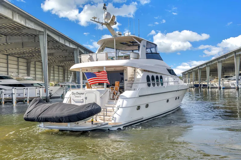 Slide: The Image of Luxury 2000 Neptunus 65 Flybridge yacht docked in marina under blue sky. - 5