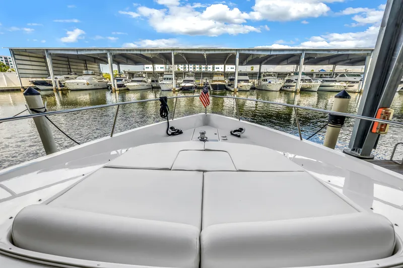 Slide: The Image of Bow view of 2000 Neptunus 65 Flybridge yacht docked at marina. - 51