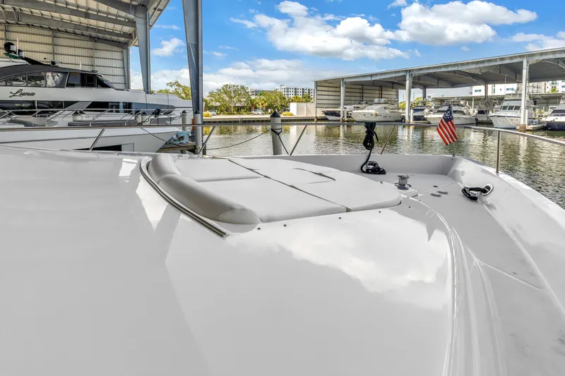 Slide: The Image of Neptunus 65 Flybridge 2000 yacht docked in marina with American flag. - 52