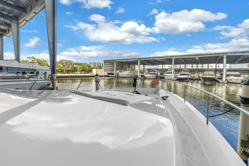 Slide: The Image of Neptunus 65 Flybridge 2000 yacht docked in a marina under a clear blue sky. - 53