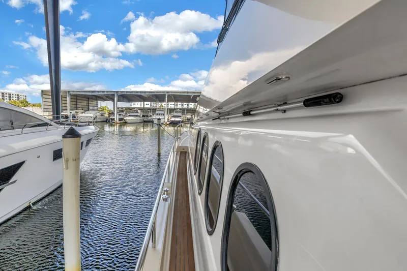 Slide: The Image of Neptunus 65 Flybridge yacht, 2000 model, docked at marina under blue sky. - 55