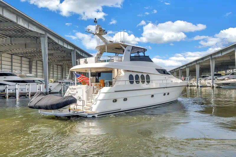 Slide: The Image of Neptunus 65 Flybridge yacht, 2000 model, docked in a marina under blue skies. - 7