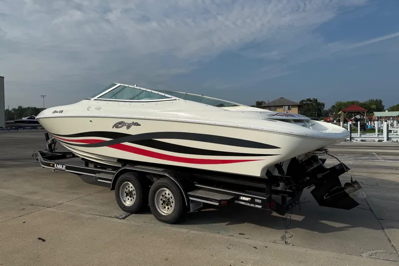 Slide: The Image of 1994 Baja Boss 272 speedboat on trailer, featuring sleek design and vibrant graphics. - 1