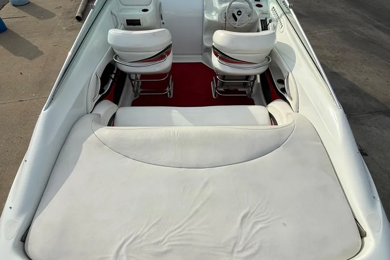 Slide: The Image of 1994 Baja Boss 272 boat interior with white seating and red carpet. - 11