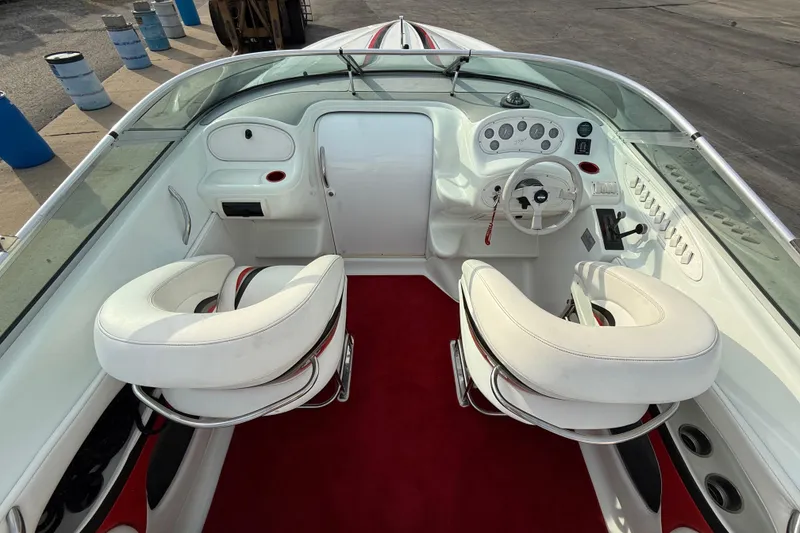 Slide: The Image of 1994 Baja Boss 272 boat interior with white seats and red carpet. - 12