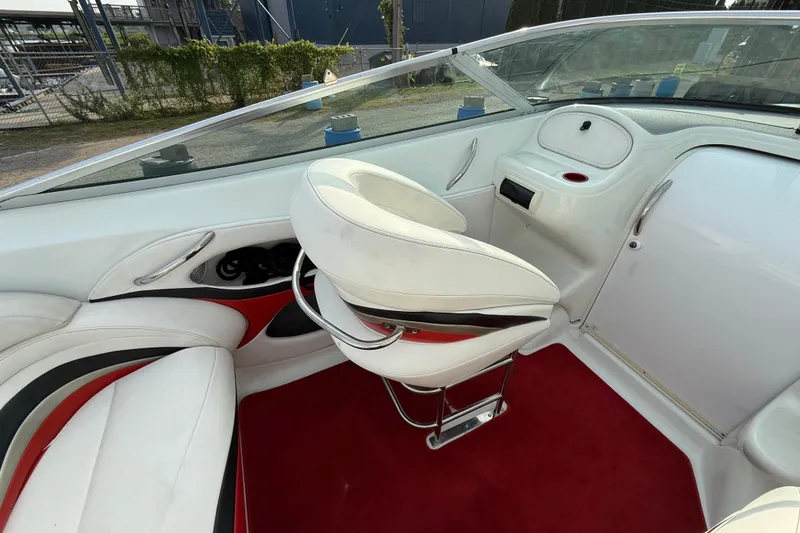 Slide: The Image of Interior of a 1994 Baja Boss 272 boat with white and red seating. - 13