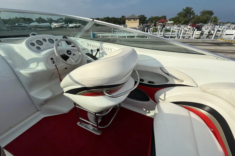 Slide: The Image of 1994 Baja Boss 272 boat interior with white and red seating, steering wheel, and dashboard. - 14