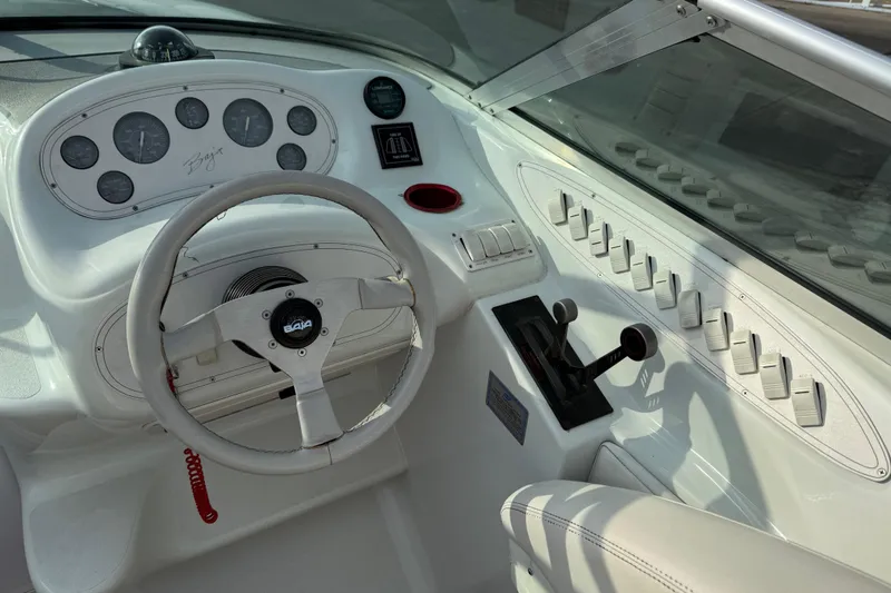Slide: The Image of 1994 Baja Boss 272 boat dashboard with steering wheel and control panel. - 15
