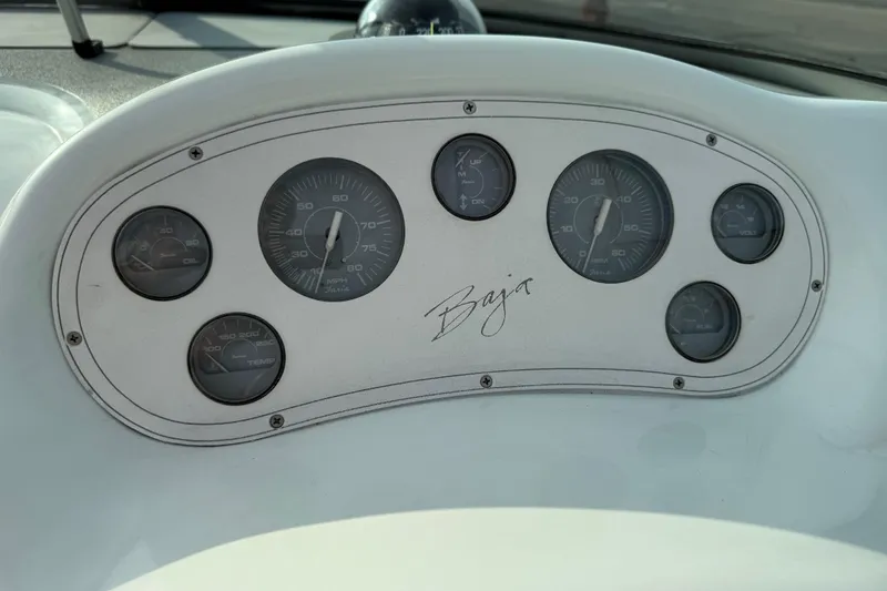 Slide: The Image of Dashboard of a 1994 Baja Boss 272 boat with gauges and Baja logo. - 16