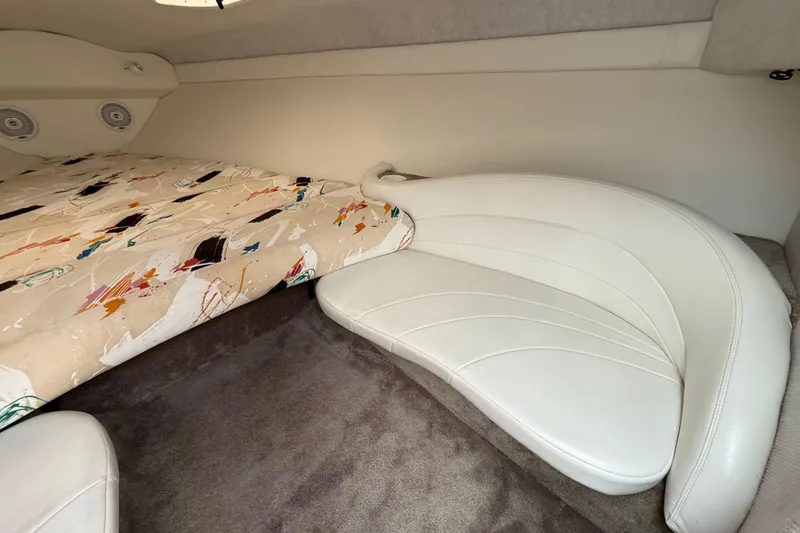 Slide: The Image of Interior of 1994 Baja Boss 272 boat with patterned bedding and white seating. - 18