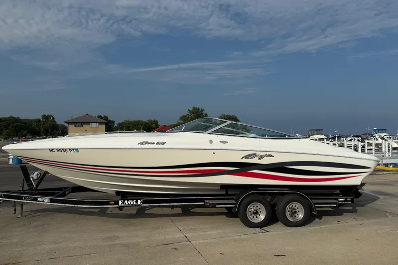 Slide: The Image of 1994 Baja Boss 272 boat on trailer, featuring sleek design and vibrant graphics. - 2