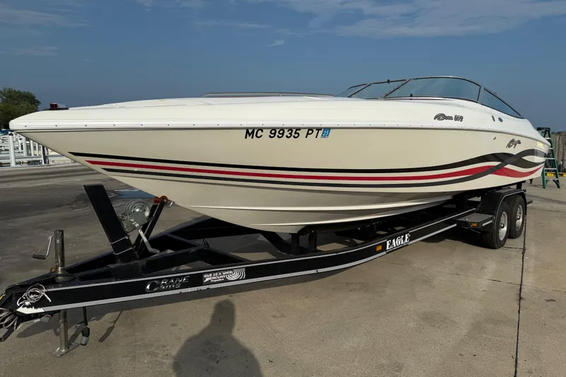 Slide: The Image of 1994 Baja Boss 272 speedboat on trailer, featuring sleek design and vibrant stripes. - 3