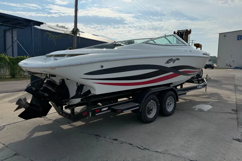 Slide: The Image of 1994 Baja Boss 272 boat on trailer, featuring sleek design and vibrant graphics. - 6