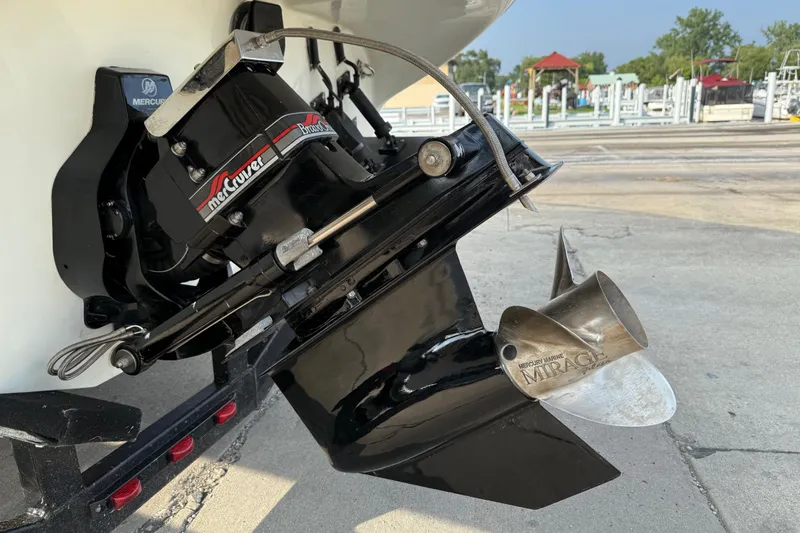 Slide: The Image of 1994 Baja Boss 272 boat with Mercury Marine Mirage propeller, docked on concrete. - 9