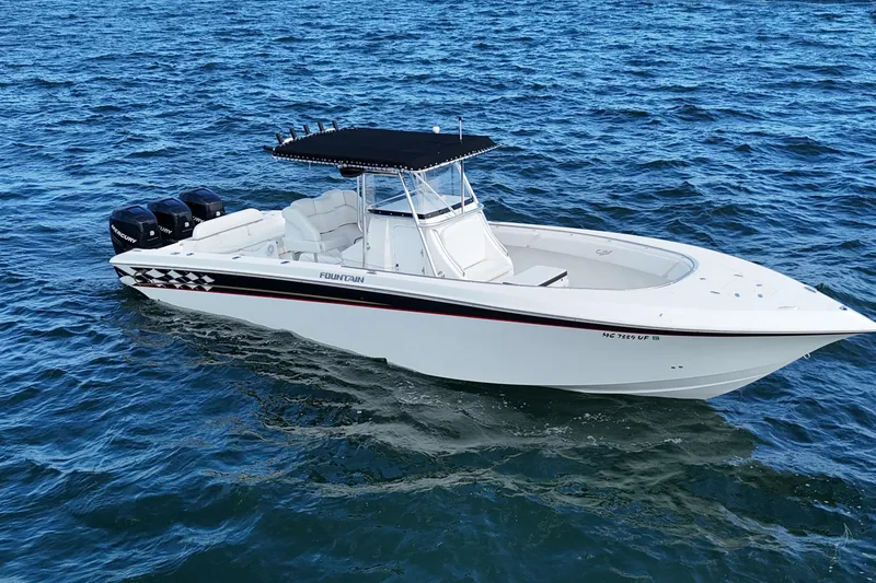 Slide: The Image of 2005 Fountain 34 Sportfish CC Open Bow boat cruising on blue ocean waters. - 0
