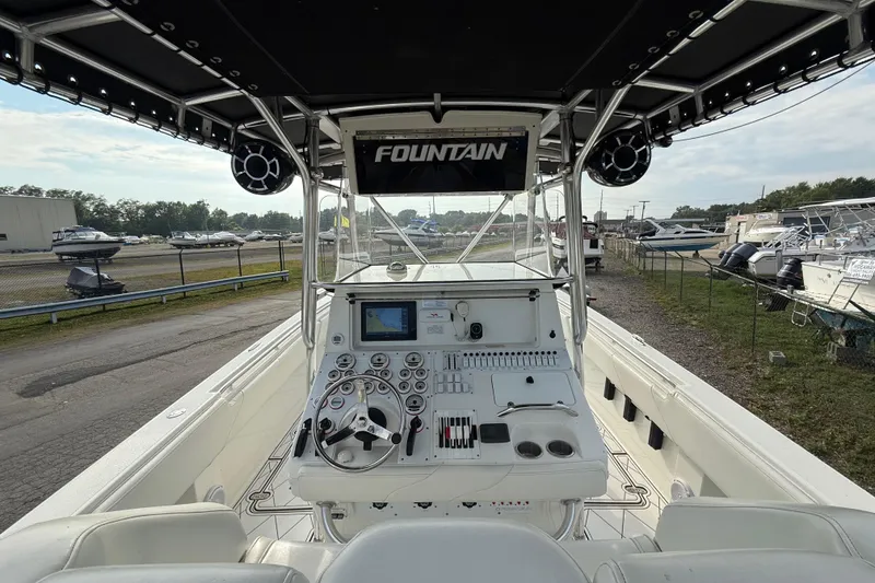 Slide: The Image of 2005 Fountain 34 Sportfish CC Open Bow boat interior with control panel and steering wheel. - 14