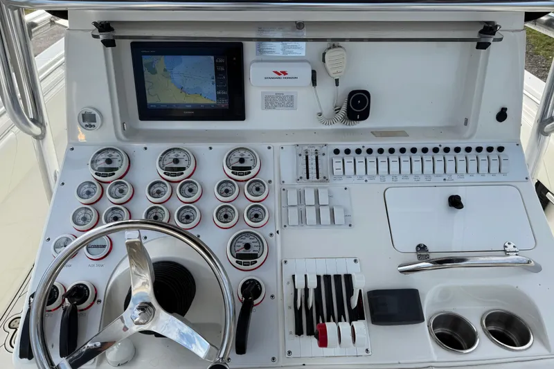 Slide: The Image of Control panel of a 2005 Fountain 34 Sportfish CC Open Bow boat with gauges and navigation screen. - 15