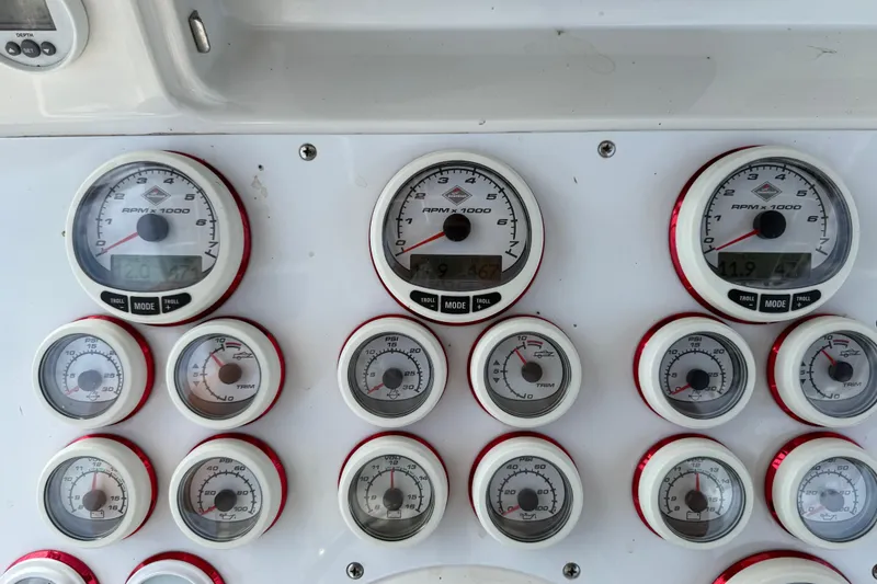 Slide: The Image of Dashboard of a 2005 Fountain 34 Sportfish CC Open Bow with multiple gauges and dials. - 16