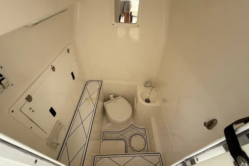 Slide: The Image of 2005 Fountain 34 Sportfish CC Open Bow boat interior with toilet and storage compartments. - 27