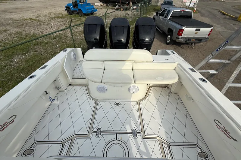 Slide: The Image of 2005 Fountain 34 Sportfish CC Open Bow with spacious seating and triple outboard engines. - 28