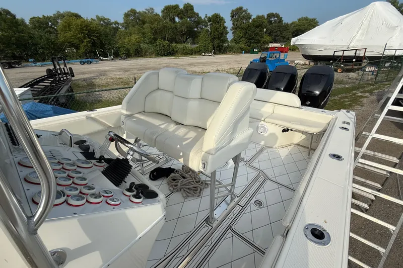 Slide: The Image of 2005 Fountain 34 Sportfish CC Open Bow with white seating and control panel. - 29