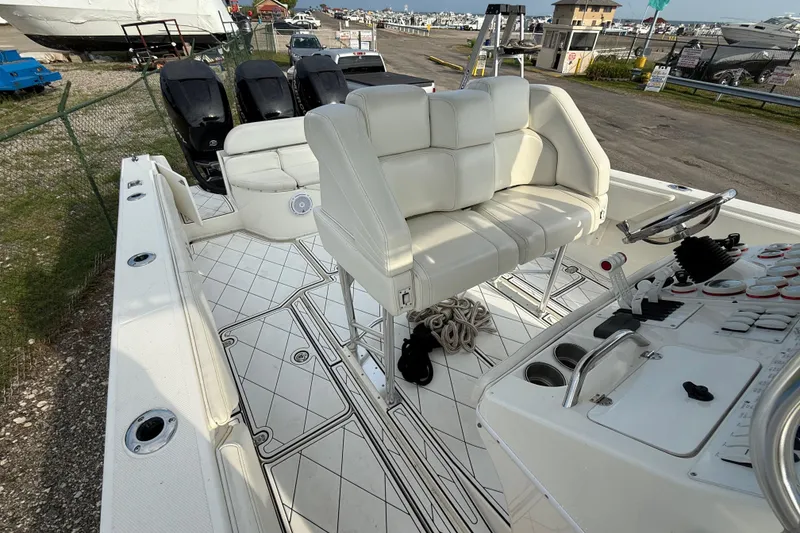 Slide: The Image of 2005 Fountain 34 Sportfish CC Open Bow with white seating and control panel. - 30