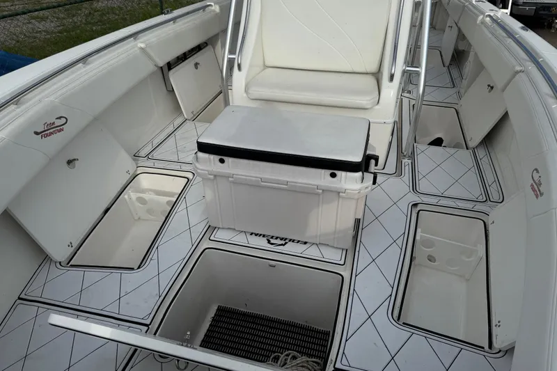 Slide: The Image of 2005 Fountain 34 Sportfish CC Open Bow interior with storage compartments and seating. - 32