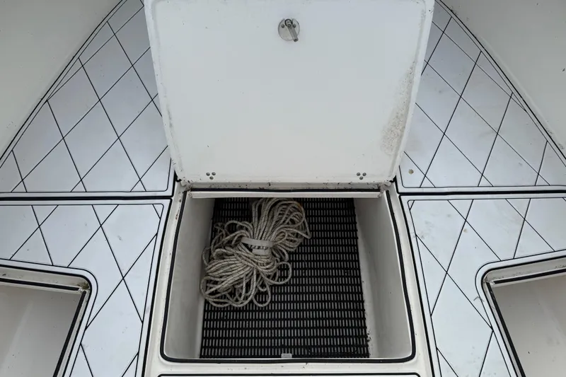 Slide: The Image of Open storage compartment on 2005 Fountain 34 Sportfish CC boat with coiled rope inside. - 33