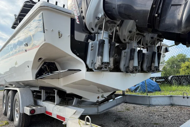 Slide: The Image of 2005 Fountain 34 Sportfish CC Open Bow on trailer, showcasing powerful outboard engines. - 34