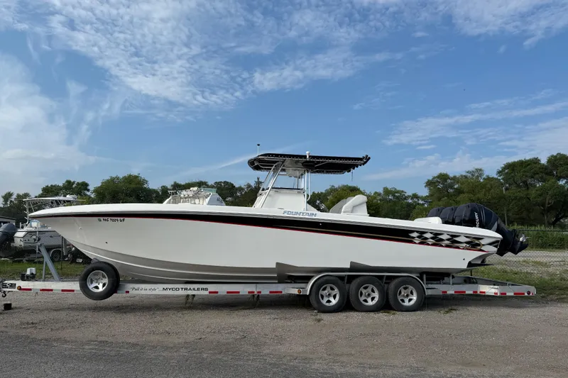 Slide: The Image of 2005 Fountain 34 Sportfish CC Open Bow on trailer under blue sky. - 38
