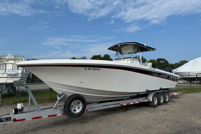 Slide: The Image of 2005 Fountain 34 Sportfish CC Open Bow on trailer, parked outdoors under blue sky. - 39