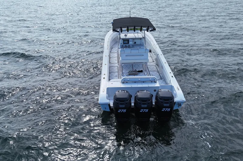 Slide: The Image of 2005 Fountain 34 Sportfish CC Open Bow on water with triple 275 engines. - 5