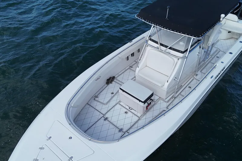 Slide: The Image of 2005 Fountain 34 Sportfish CC Open Bow on water, featuring spacious deck and seating. - 7