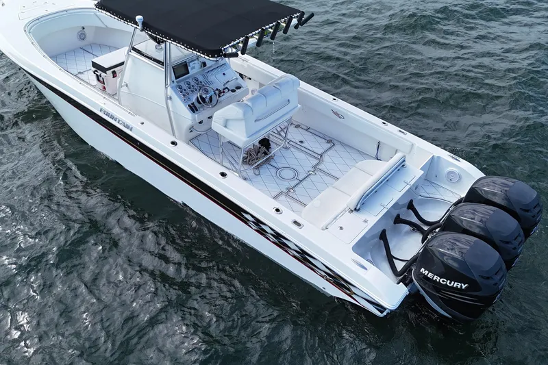 Slide: The Image of 2005 Fountain 34 Sportfish CC Open Bow with triple Mercury engines on water. - 8